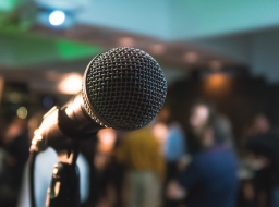 A microphone in front of a crowd of people.