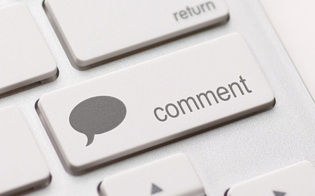 A close up of a keyboard with a comment button on it.