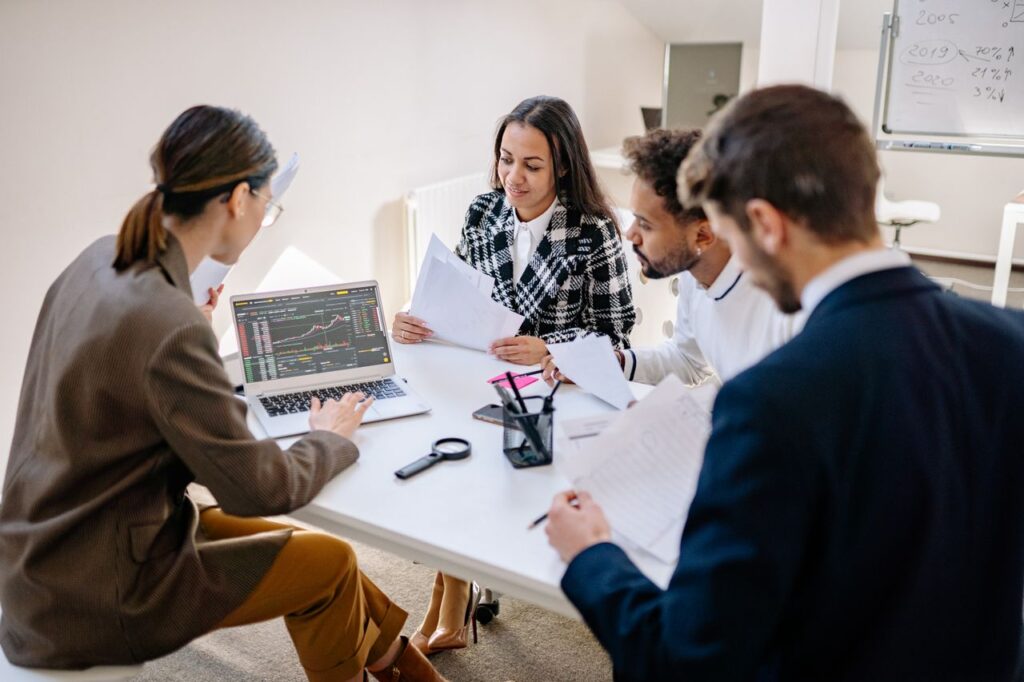 Government project team reviewing data and project information on a laptop, as part of how ai in government is transforming public service delivery